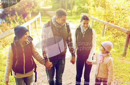 Image of happy family with backpacks hiking
