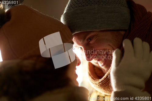 Image of close up of happy couple in winter clothes