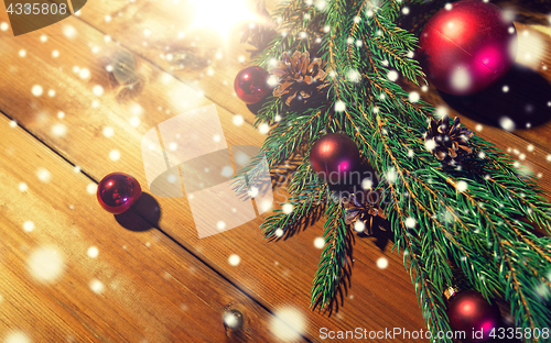 Image of fir branch with christmas ball and pinecones