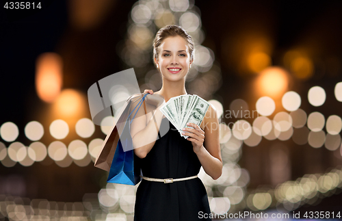 Image of woman with shopping bags and money at christmas