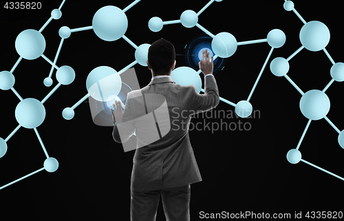 Image of businessman working with molecule formula