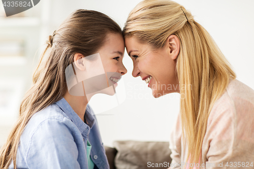 Image of happy smiling family of girl and mother at home