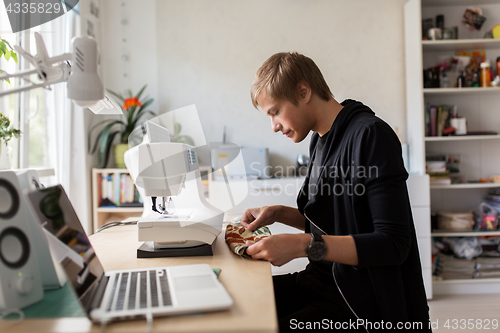 Image of fashion designer with making dress at studio