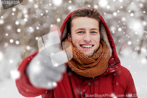 Image of happy man in winter jacket showing thumbs up