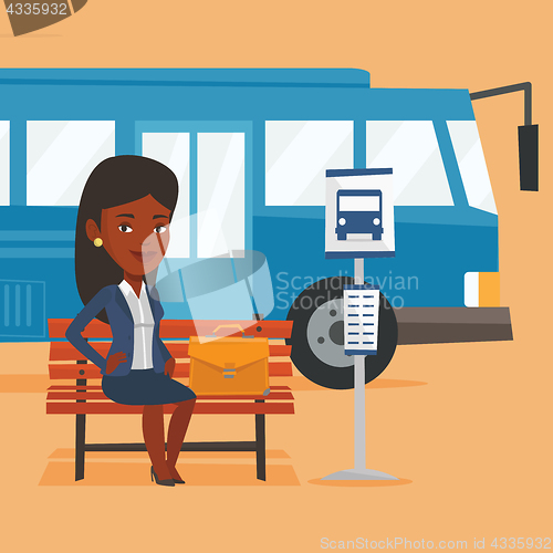 Image of Business woman waiting at the bus stop.