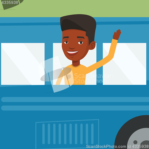 Image of African-american man waving hand from bus window.