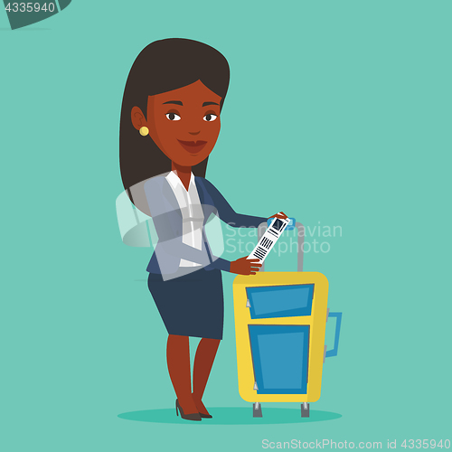 Image of African-american businesswoman showing luggage tag