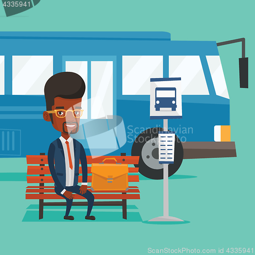 Image of Business man waiting at the bus stop.