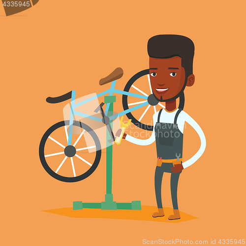 Image of African bicycle mechanic working in repair shop.