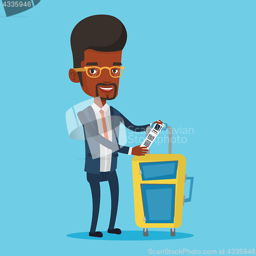 Image of African-american business man showing luggage tag.