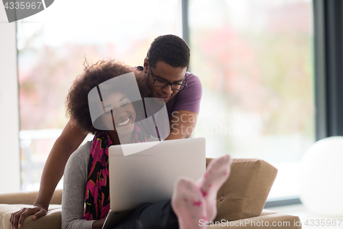 Image of african american couple shopping online