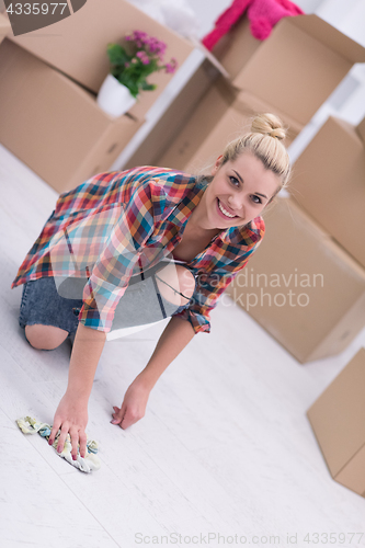 Image of woman cleaning the floor at home