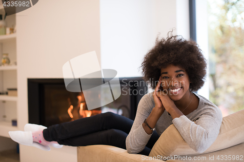 Image of black woman in front of fireplace