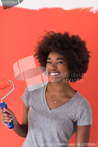 Image of black woman painting wall