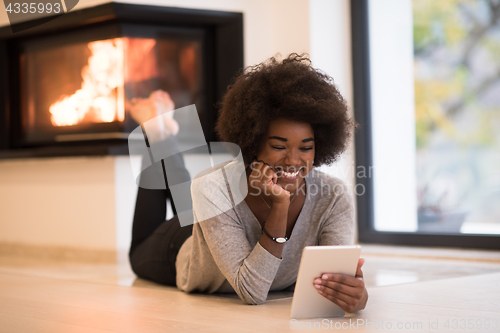 Image of black women using tablet computer on the floor