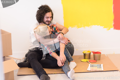 Image of Happy young couple relaxing after painting