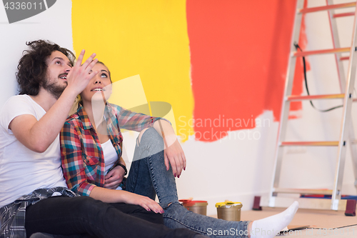 Image of Happy young couple relaxing after painting