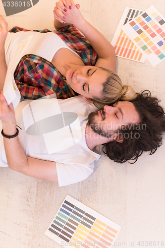 Image of Happy young couple relaxing after painting