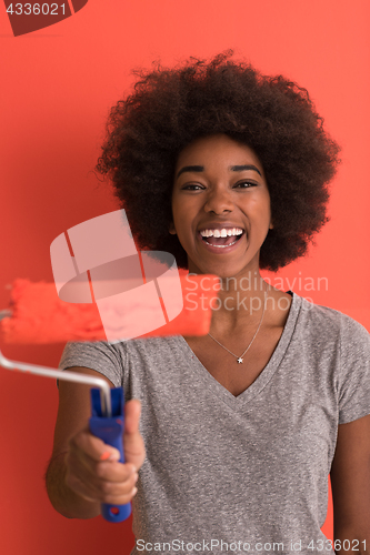 Image of black woman painting wall