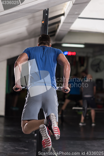 Image of man doing exercises parallel bars