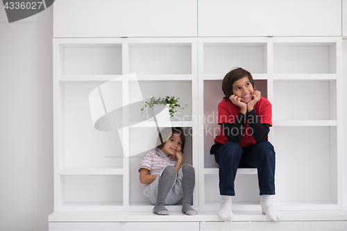 Image of young boys posing on a shelf