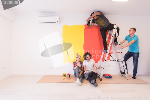 Image of Happy young couple relaxing after painting