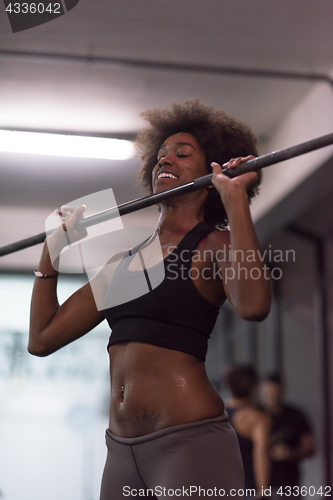 Image of black woman lifting empty bar