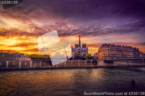 Image of Notre Dame Cathedral with Paris cityscape at dusk