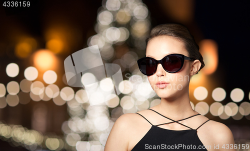 Image of beautiful woman in black sunglasses at christmas