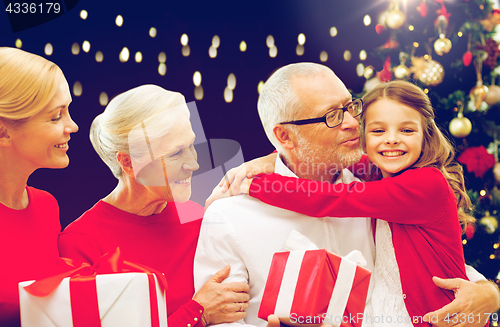 Image of happy family with christmas gifts