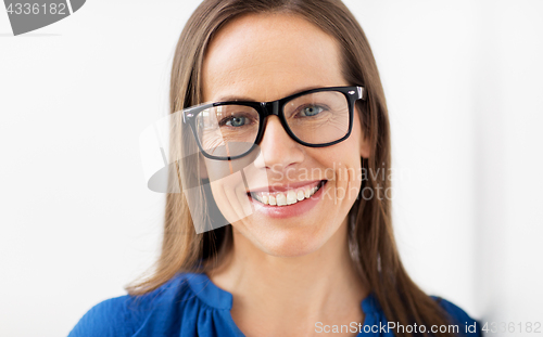 Image of close up of smiling middle aged woman in glasses