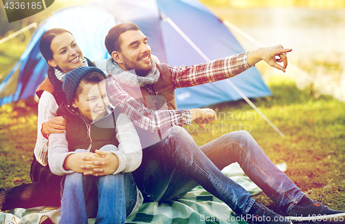 Image of happy family with tent at camp site