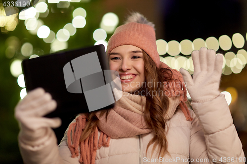 Image of woman with tablet pc at christmas tree outdoors