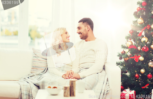 Image of happy couple at home with christmas tree