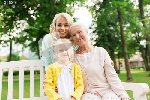 Image of woman with daughter and senior mother at park