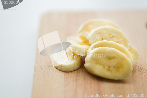 Image of close up of banana on wooden cutting board