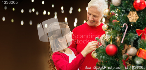 Image of happy family decorating christmas tree