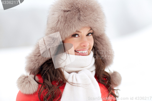 Image of close up of happy woman in winter fur hat outdoors