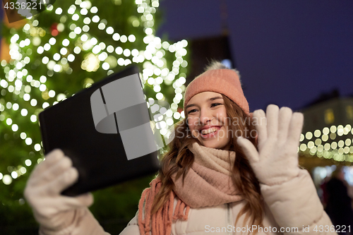 Image of woman with tablet pc at christmas tree outdoors