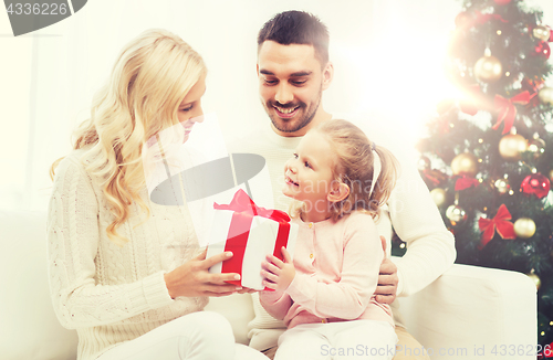 Image of happy family at home with christmas tree
