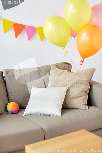 Image of sofa at home room decorated for birthday party