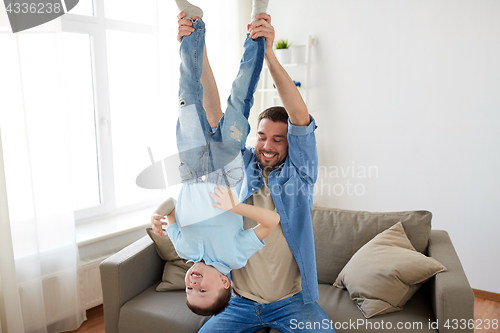 Image of father with son playing and having fun at home