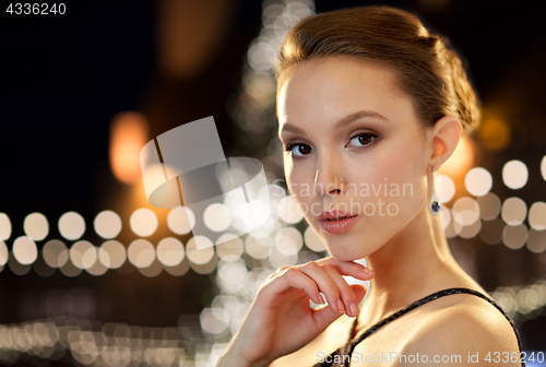 Image of beautiful asian woman with earrings at christmas