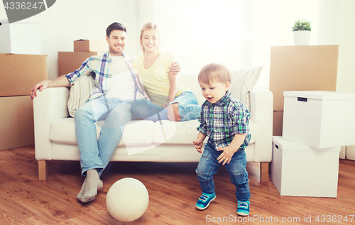 Image of happy family moving to new home and playing ball