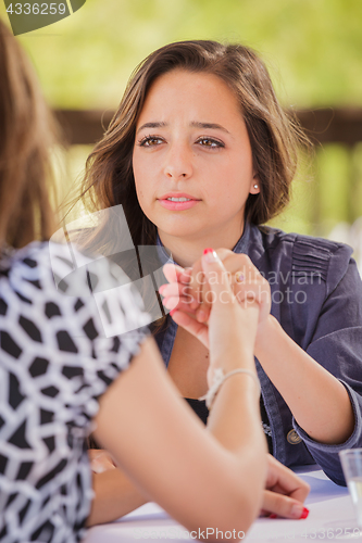 Image of Concerned Young Adult Woman Talking With Her Friend