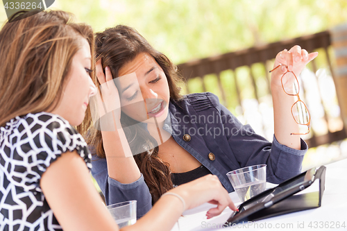 Image of Expressive Young Adult Girlfriends Using Their Computer Electron