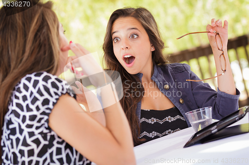 Image of Expressive Young Adult Girlfriends Using Their Computer Electron