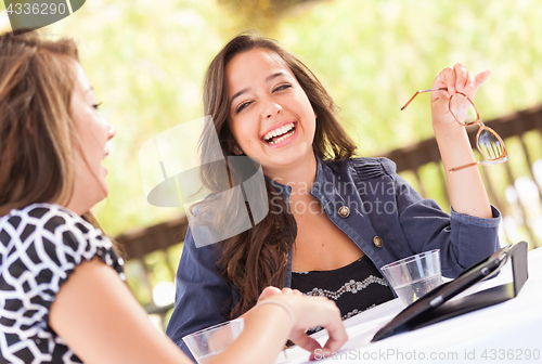 Image of Expressive Young Adult Girlfriends Using Their Computer Electron