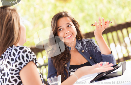 Image of Expressive Young Adult Girlfriends Using Their Computer Electron