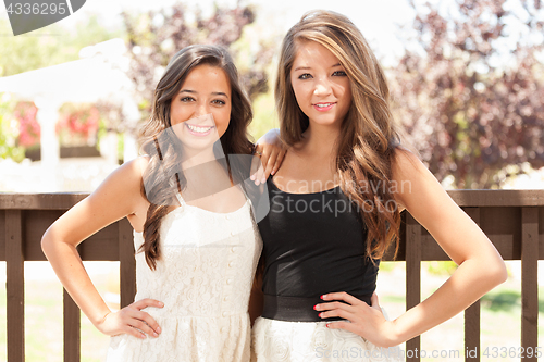 Image of Two Mixed Race Girlfriends Pose for Portrait Outdoors